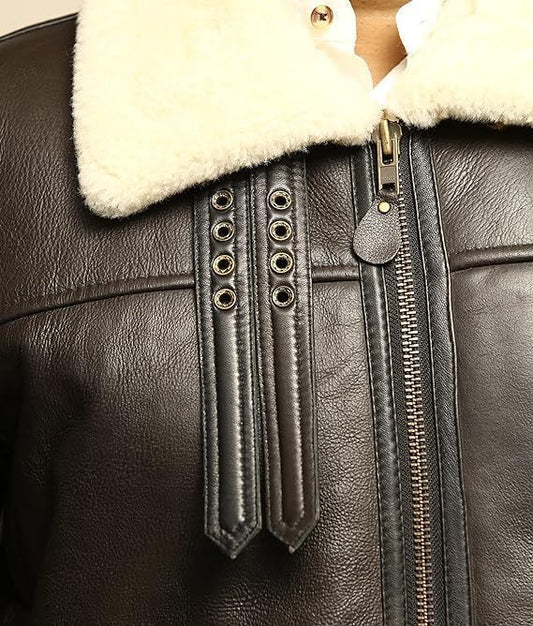 Close-up of a black leather jacket with white fur lining and decorative buttons.