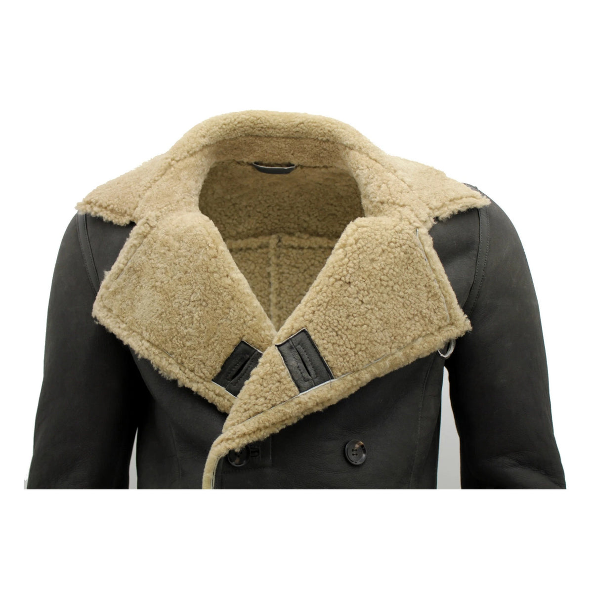 A close-up of a men's double-breasted jacket featuring a dark charcoal brown leather body and a thick, warm beige sherpa fleece collar and lining.