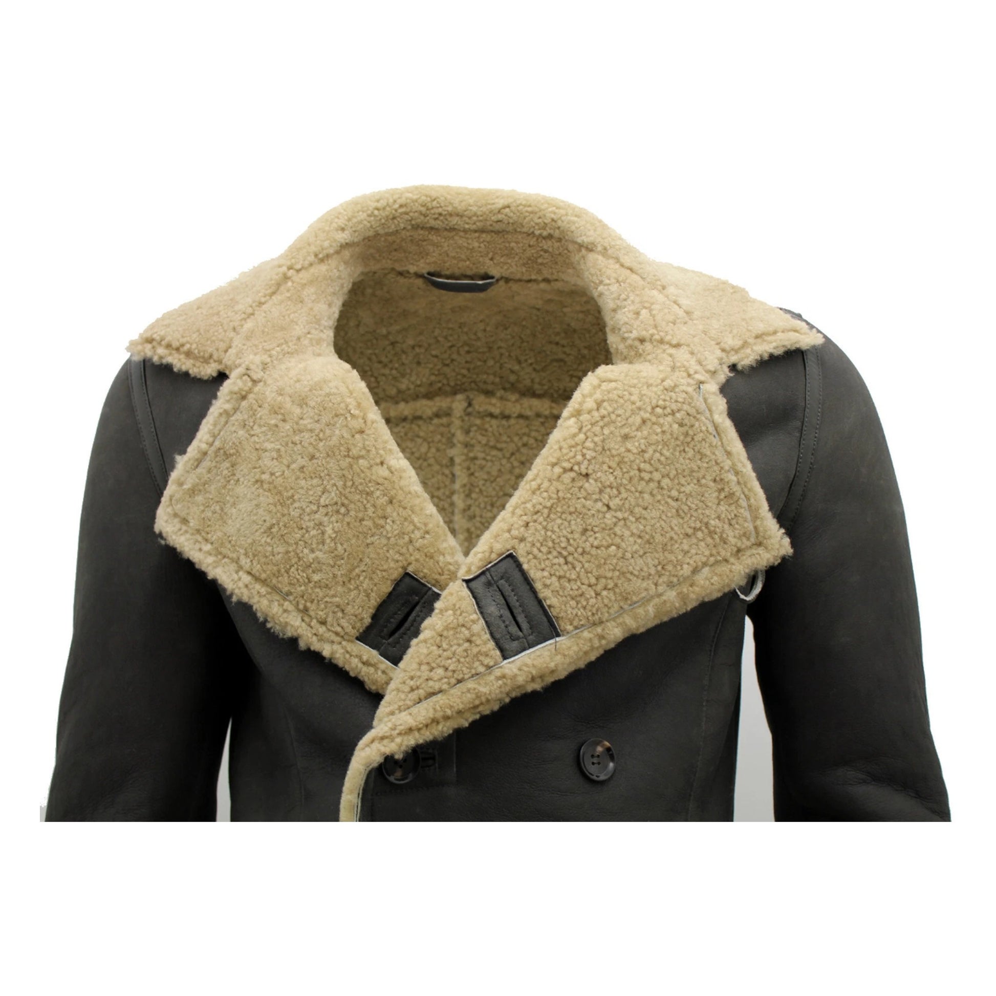 A close-up of a men's double-breasted jacket featuring a dark charcoal brown leather body and a thick, warm beige sherpa fleece collar and lining.