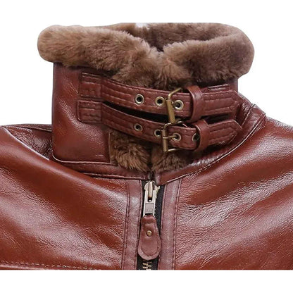 Close-up of a brown leather jacket with a high collar, double buckle strap detail, and plush brown faux-fur trim around the neck and collar, shown against a white background.