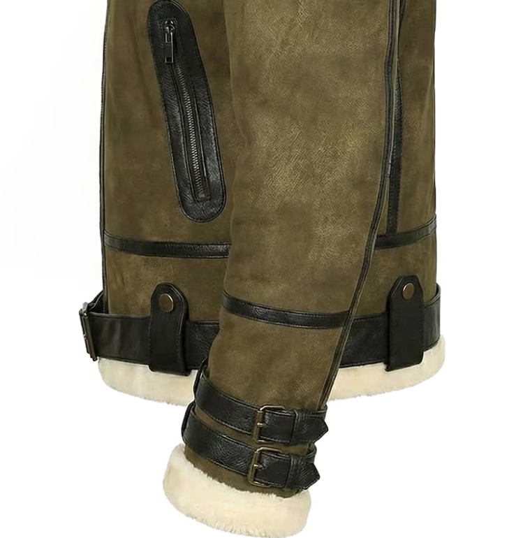 Close-up of olive green suede aviator-style boots with black leather trim, straps, buckles, and a cream shearling lining visible at the cuffs and sole.