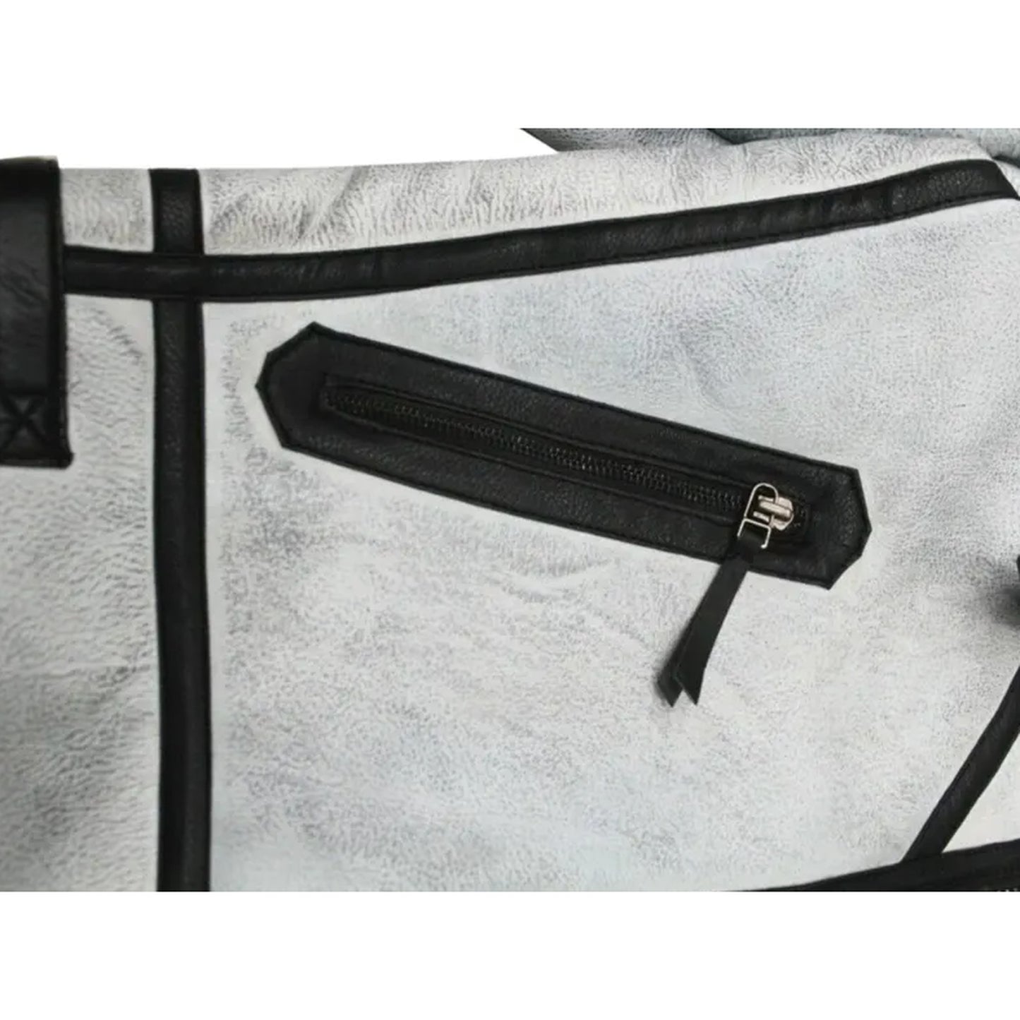 Close-up of a light gray textured leather bag with black trim and a black zippered pocket featuring a silver-tone metal pull.