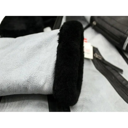 Black car handbrake cover on a car interior with a white towel.