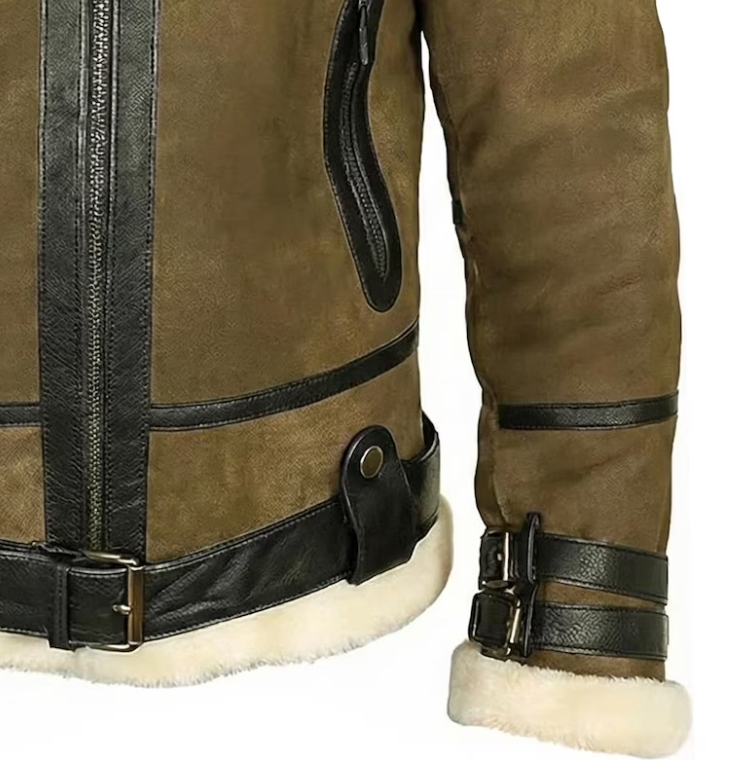 Close-up of a brown suede aviator-style jacket with black leather trim, zippers, and straps, showing the sleeve and lower torso with a white shearling lining.