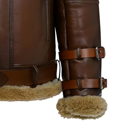 Close-up of brown leather aviator-style boots with tan shearling lining and adjustable leather straps with metal buckles, shown on a white background.